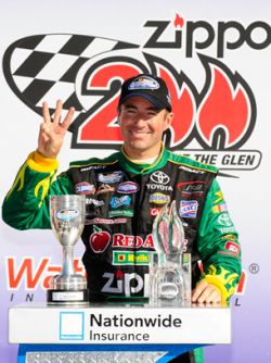 Marcos Ambrose raises three fingers in recognition of his third consecutive NASCAR Nationwide Series victory at Watkins Glen International Saturday in Watkins Glen, N.Y. Credit: Rusty Jarrett/Getty Images for NASCAR